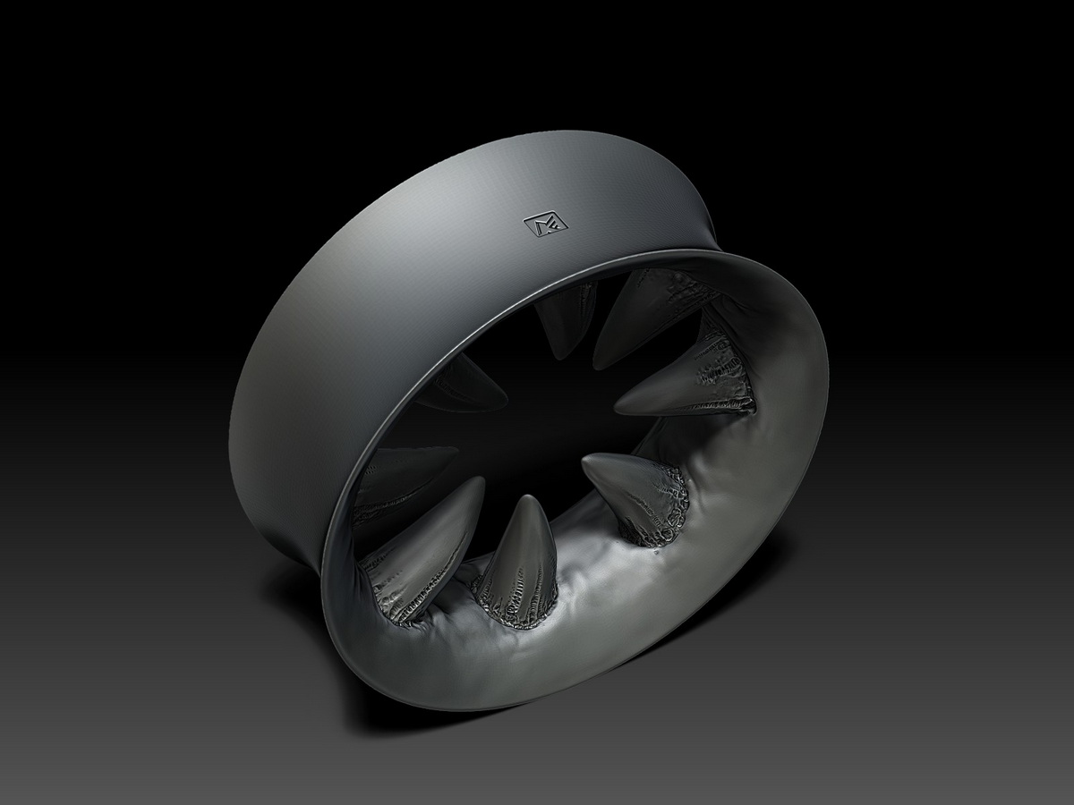 Angled view of an original fanged ear tunnel design in titanium, highlighting the dimensional form of the sculpted gums and inward-facing teeth.